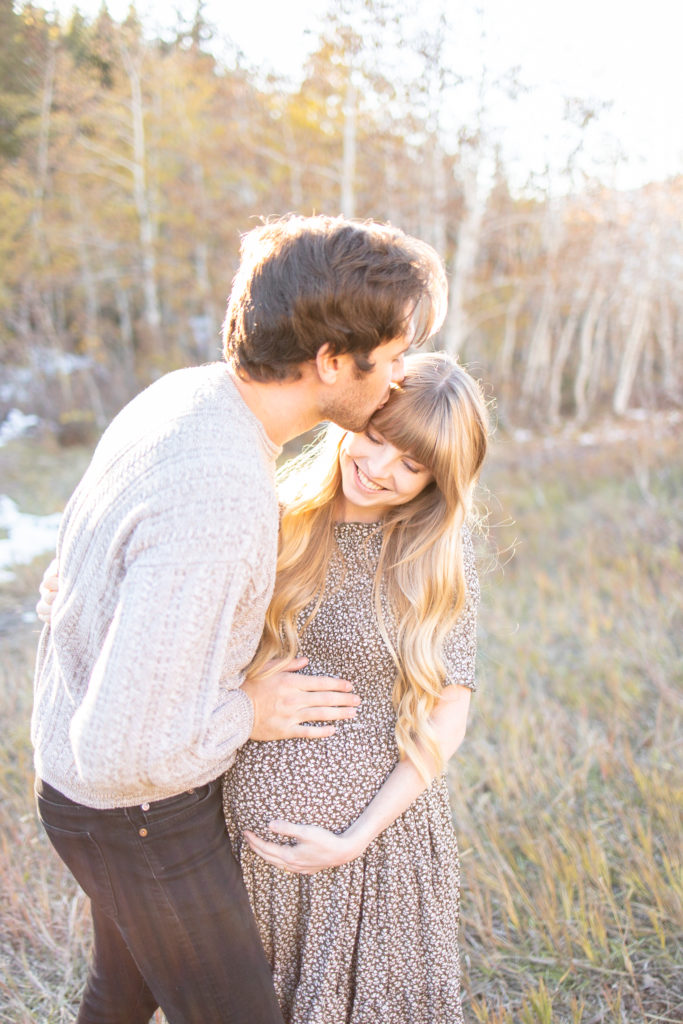 Husband kissing pregnant wife, couple maternity photos by Alisa Dalton Photography. 