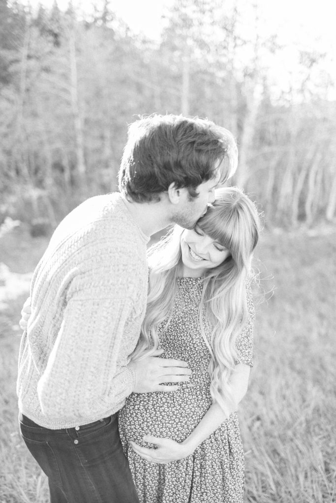 Husband kissing pregnant wife, couple maternity photos by Alisa Dalton Photography. 